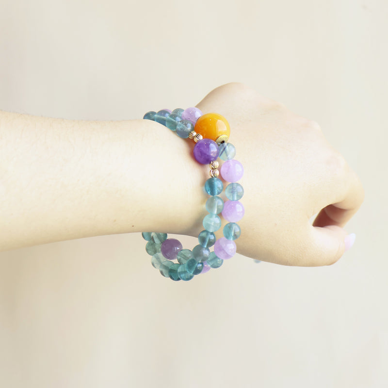 Crystal Veil Amethyst Fluorite bracelet worn on wrist showing colorful crystal style and everyday jewelry look