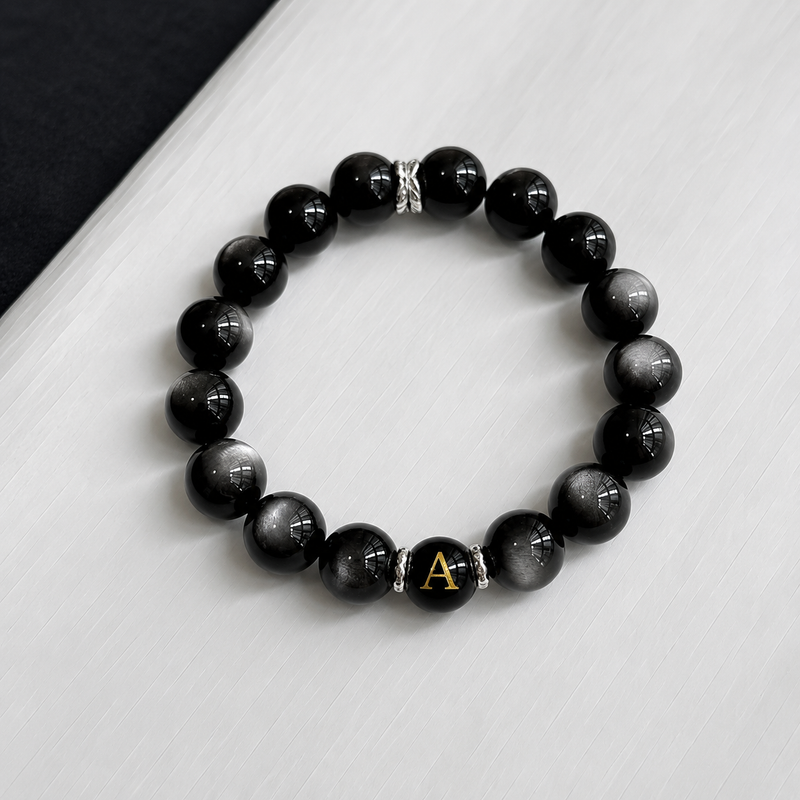 Crafted with natural Silver Obsidian and finished with your selected initial, creating a timeless bracelet designed for everyday wear.