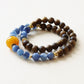 Close up of natural agarwood and kyanite bead bracelet featuring blue gemstone beads and handcrafted details