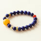 Astral Orbit Zenith Crystal Bracelet featuring natural Lapis Lazuli gemstone beads and Red Agate accent stone with AI companion bead in clean studio white background presentation