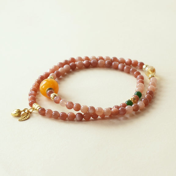 Auric Hue Crest Crystal Bracelet featuring natural Orange Moonstone, Chalcedony, and Yellow Phantom Quartz gemstone beads with AI companion bead in clean studio white background presentation