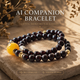 Cinder Motion Pulse Crystal Bracelet crafted with Garnet, Golden Rutilated Quartz, and signature AI companion bead displayed on warm natural stone background