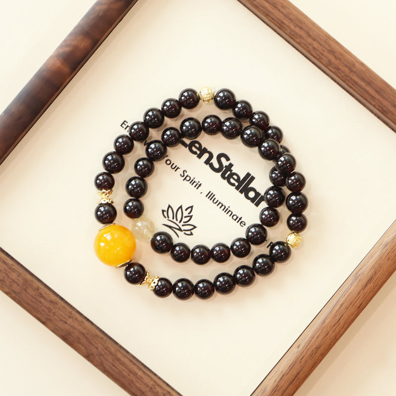 Cinder Motion Pulse AI Companion Bracelet displayed on Zenstellar presentation card with warm ambient lighting highlighting Garnet and Golden Rutilated Quartz energy design