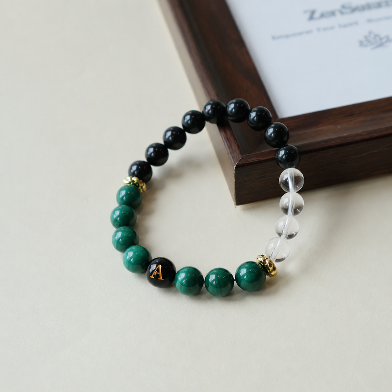 Personalized initial bracelet crafted with natural Malachite, Black Tourmaline and Clear Quartz, displayed with a custom black letter bead.