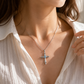 Woman wearing sterling silver faith cross necklace, elegant gemstone jewelry for daily wear