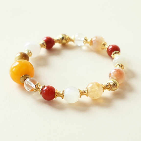 Golden Dawn Radiance Crystal Bracelet featuring rutilated quartz, moonstone, golden tiger eye, clear quartz, and carnelian gemstones