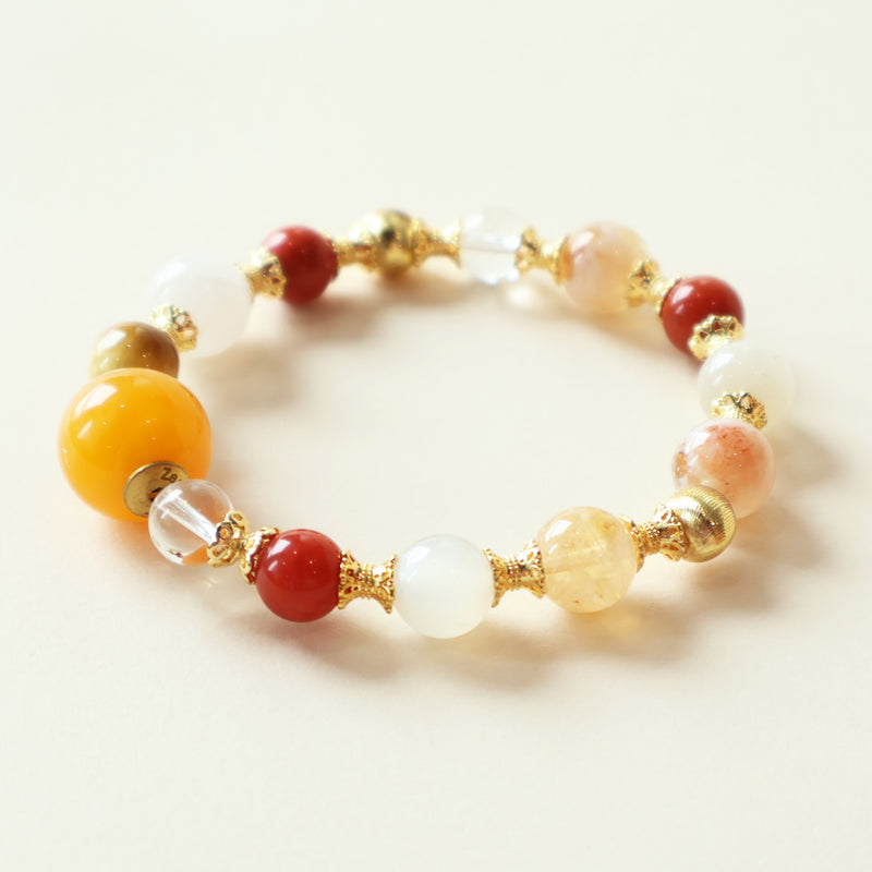 Golden Dawn Radiance Crystal Bracelet featuring rutilated quartz, moonstone, golden tiger eye, clear quartz, and carnelian gemstones