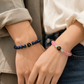 Couple wearing Harmony Link™ personalized Blue Tiger Eye, Strawberry Quartz and Aquamarine initial bracelets, handcrafted with natural gemstones for meaningful everyday connection.