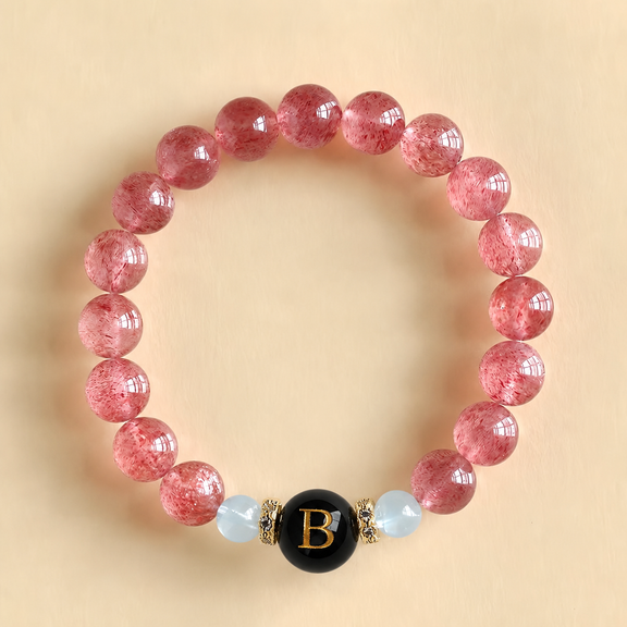 Women's Harmony Link™ personalized Strawberry Quartz and Aquamarine bracelet featuring a custom black initial bead, handcrafted with natural gemstones.