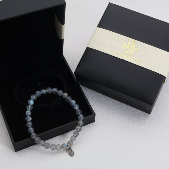 Lunar Mist grey moonstone bracelet displayed in an open black gift box with its matching lid beside it