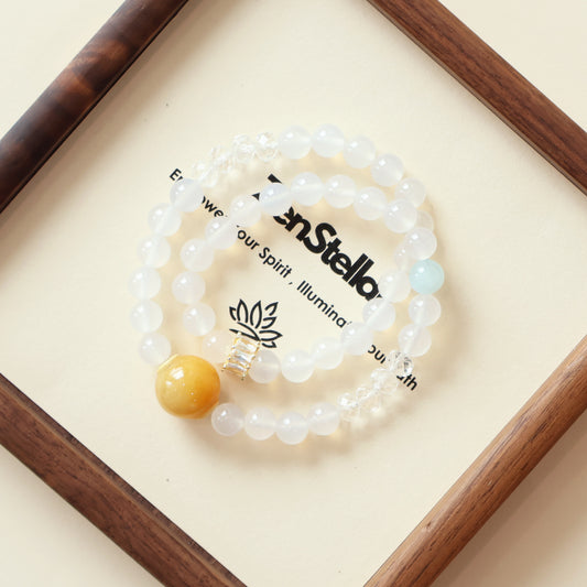Silent Current Meridian AI companion bracelet displayed on a clean minimalist surface, featuring White Agate, Clear Quartz, and Aquamarine crystals representing emotional balance, clarity, and gentle flow energy.