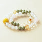 Snow Meadow Aether crystal bracelet featuring snowflake phantom matcha alashan and citrine accents displayed on clean white background product composition