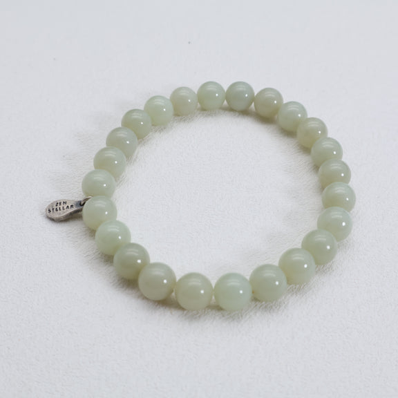 Close view of the Soft Meadow pale green jade bracelet worn on the wrist