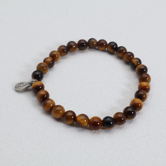 Detail of the 925 sterling silver charm on a tiger's eye bead bracelet
