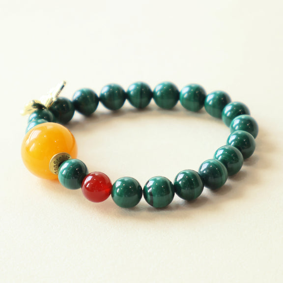 Close-up view of Verdant Lattice Quiet Crystal Bracelet showing 8mm Malachite and Red Agate gemstone beads with butterfly accent and polished crystal texture