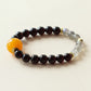 Close-up view of natural Garnet and Grey Moonstone beads highlighting crystal texture and organic gemstone patterns.